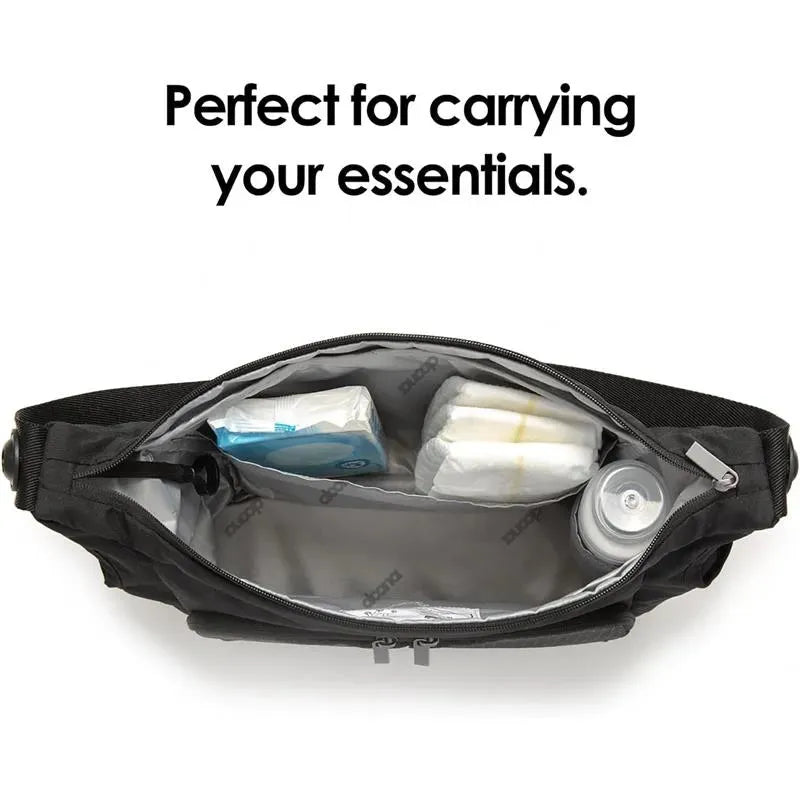Doona Essentials Bag in Nitro Black with an open zipper showcasing compartments for baby items and a can.