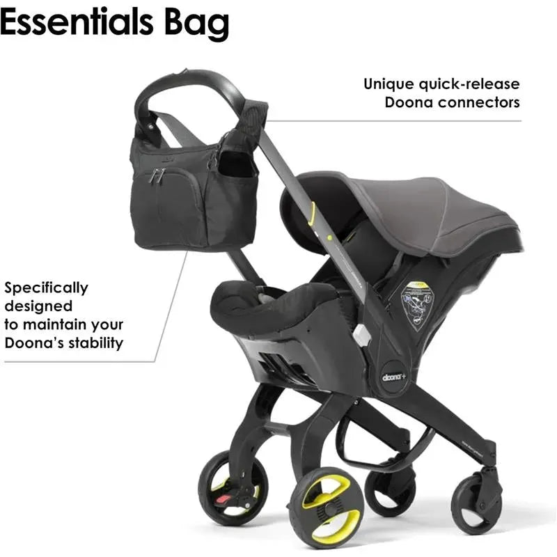 Essentials Bag for Doona in Nitro Black, featuring a spacious pocket and quick-release connectors to maintain stroller stability.