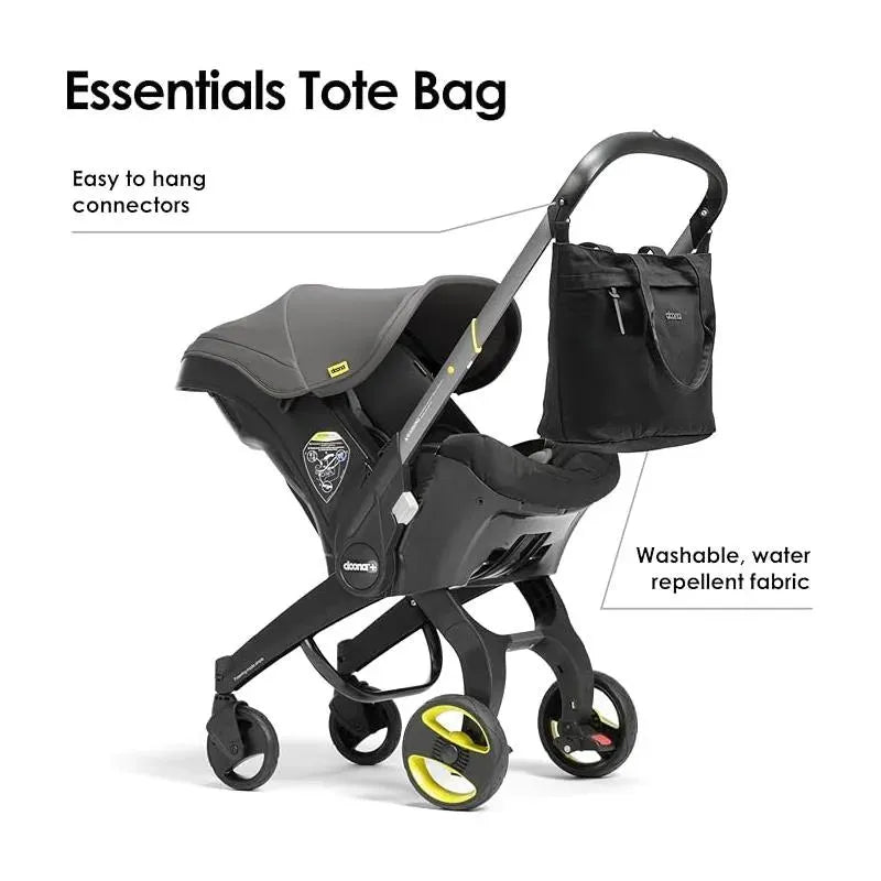 Essentials Diaper Tote Bag in Nitro Black with easy connectors; shown with Doona stroller, labeled for washable, water-repellent fabric.