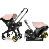 Doona infant car seat with base and stroller in blush pink, featuring a detachable seat and adjustable handle.