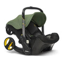 Doona infant car seat and stroller in desert green, featuring a collapsible design with a large canopy and sleek black base.