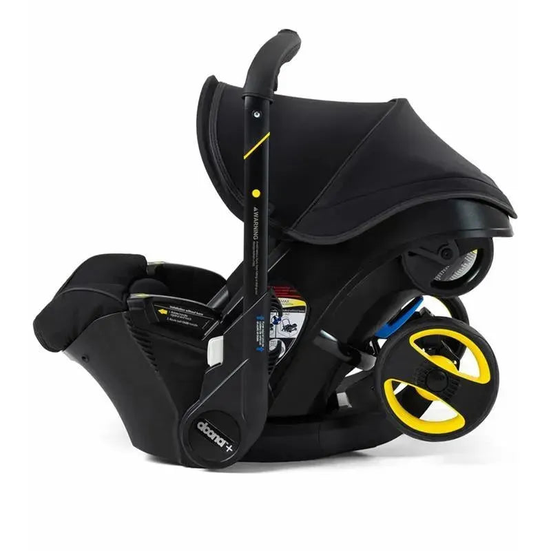 Doona Infant Car Seat and Stroller in Midnight color, featuring a sleek black design, integrated wheels, and adjustable canopy.