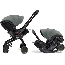 Doona X Infant Car Seat in Slate Green, featuring a removable canopy and integrated wheels for easy transport.