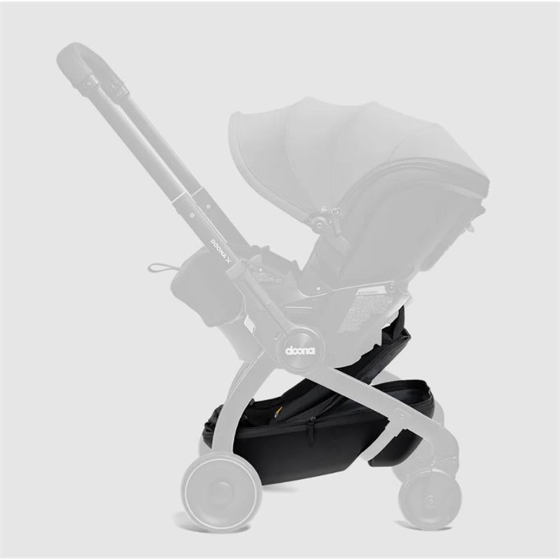 Doona X Pack & Go Basket in black attached to a stroller with a canopy, showcasing the storage compartment below.