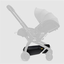 Black Doona X Storage Basket attached to a Doona stroller, designed for convenient storage underneath the seat.