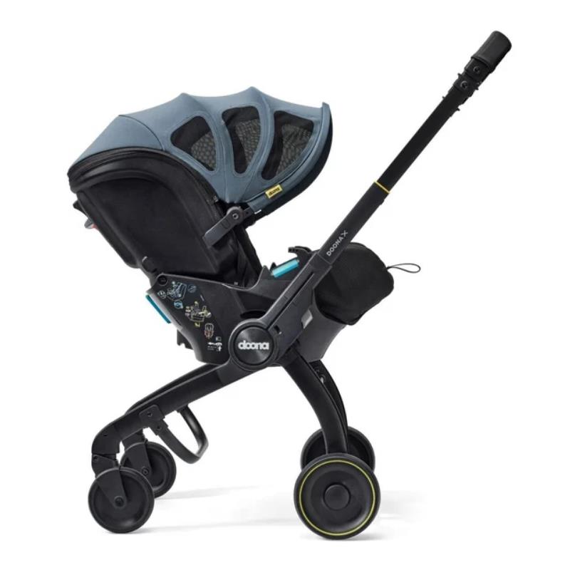 Doona X Summer Canopy in Ocean Blue, a car seat that converts to a stroller, showing adjustable canopy and wheels.