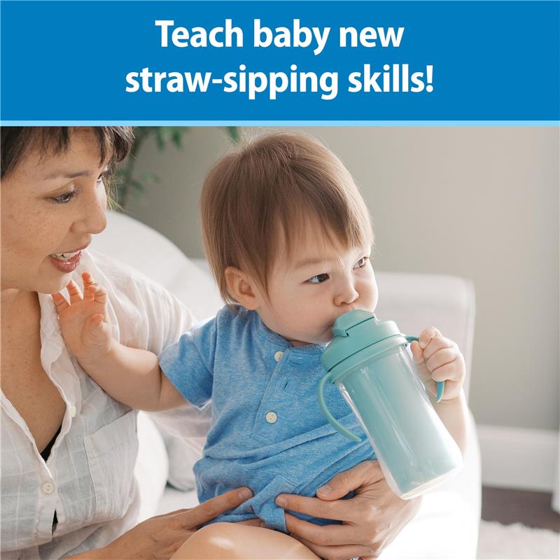 Toddler drinking from a light green Dr. Brown insulated straw cup, while seated with an adult.