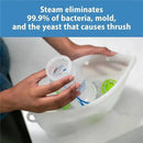 Hands placing a baby bottle into a Dr Brown 100% Silicone Microwave Steam Sterilizer Bag, highlighting its use for sterilization.
