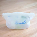 Reusable 100% silicone microwave steam sterilizer bag with blue design, placed on a wooden surface.