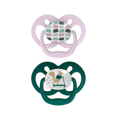 Two Dr. Brown Advantage Pacifiers in Stage 2: one pink with geometric patterns, and one green featuring a squirrel on a scooter.