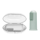 Silicone finger toothbrush in light green next to a white carrying case, designed for infant dental care.