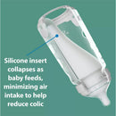 Dr. Brown 9 oz silicone baby bottle in pink, featuring a collapsing insert to minimize air intake and reduce colic.