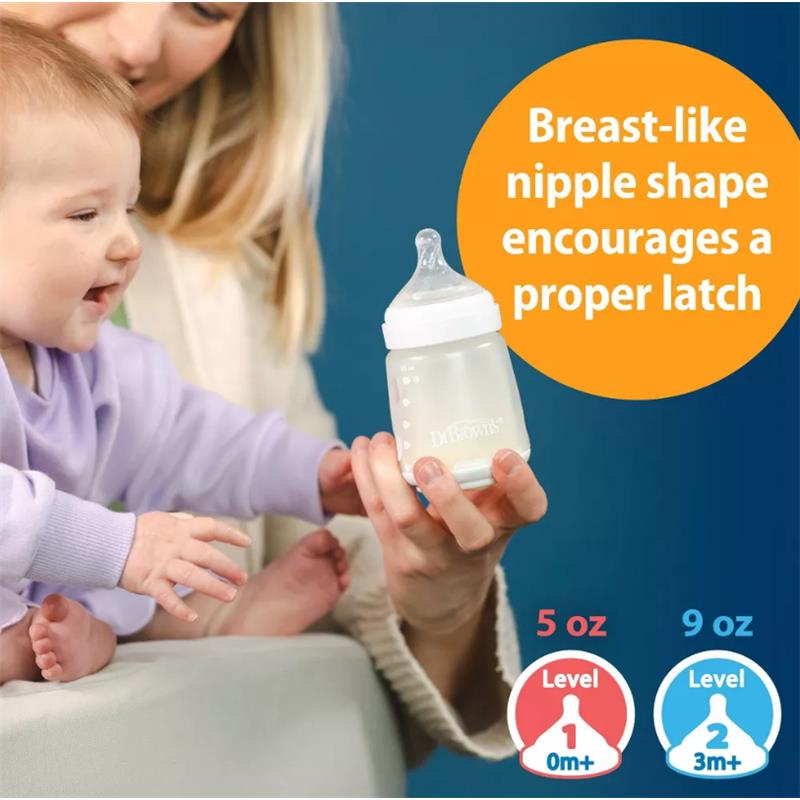 Silicone baby bottles in pink, featuring a breast-like nipple shape for proper latching, held by a caregiver with a baby.