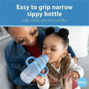 Light blue narrow sippy bottle with silicone handles. A child is drinking from it while being held by a caregiver.