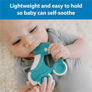 Baby holding a teal roller skate-shaped teether, designed for self-soothing, while lying on a soft surface.