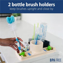Silicone mat with two bottle brush holders, several cleaning tools, and baby bottles, labeled BPA-free.