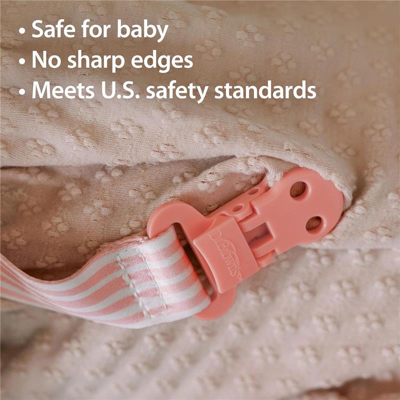 Pink pacifier clip with a striped fabric strap, featuring text highlighting safety features for babies.