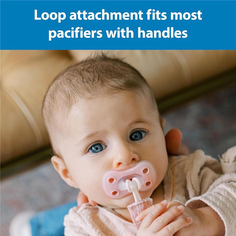 Baby with blue eyes holding a pink pacifier in their mouth, featuring a loop attachment for secure fit.