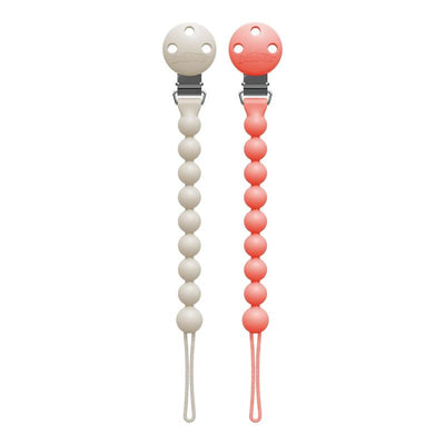 Two silicone pacifier clips in pink and ecru colors, with a round clip and bead designs for securing pacifiers.