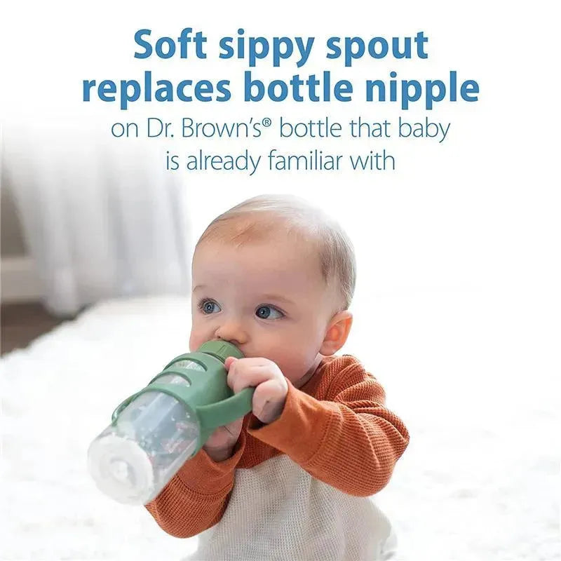 Soft sippy spout bottle with silicone handles in green, held by a baby, promoting transition from bottle nipple.