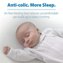 Sleeping baby in a white onesie with text about anti-colic benefits and air-free feeding for comfort.