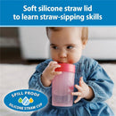 Pink coral training cup with soft silicone straw, held by a toddler learning to sip, labeled as spill-proof.