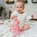 Wide-neck pink sippy straw bottle with silicone handles, featuring a baby reaching for it.