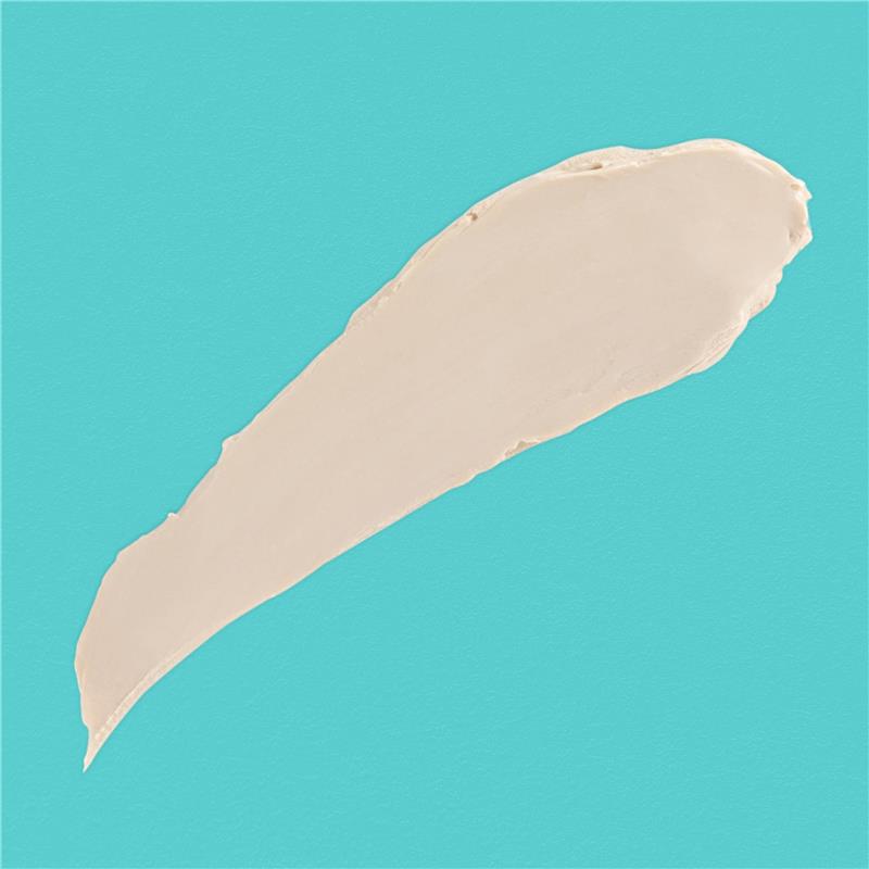 Beige diaper rash ointment spread on a turquoise background, highlighting its creamy texture.