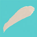 Beige diaper rash ointment spread on a turquoise background, highlighting its creamy texture.