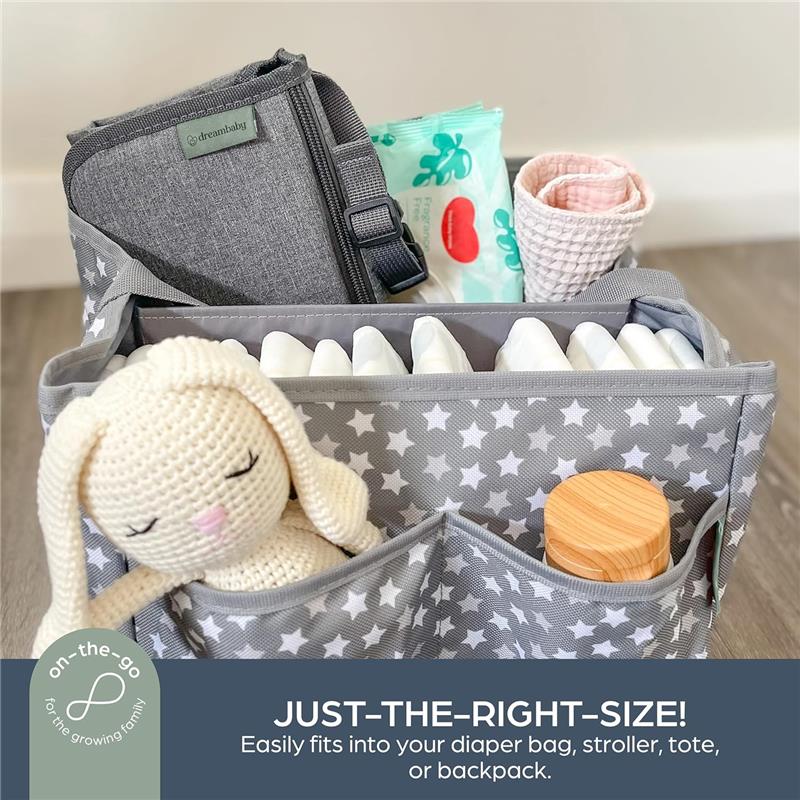 Charcoal change mat by Dreambaby, shown alongside diapers, wipes, a toy, and a wooden container in a star-patterned organizer.