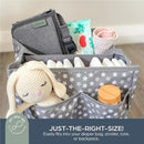 Charcoal change mat by Dreambaby, shown alongside diapers, wipes, a toy, and a wooden container in a star-patterned organizer.
