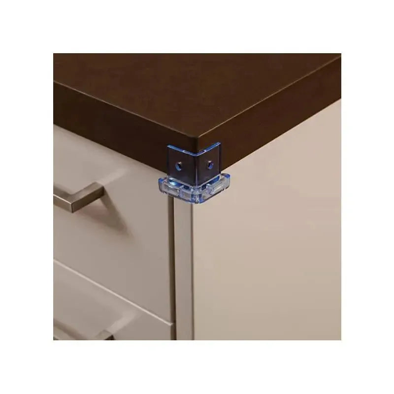 Clear blue corner cushion attached to a brown tabletop edge, designed for child safety.