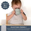 Little boy drinking from a seafoam-colored Dreambaby Drink & Snack Cup, which holds 6 oz (180 mL).