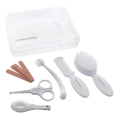 Dreambaby Essential Grooming Kit in white with scissors, comb, brush, nail clippers, and files in a clear case.