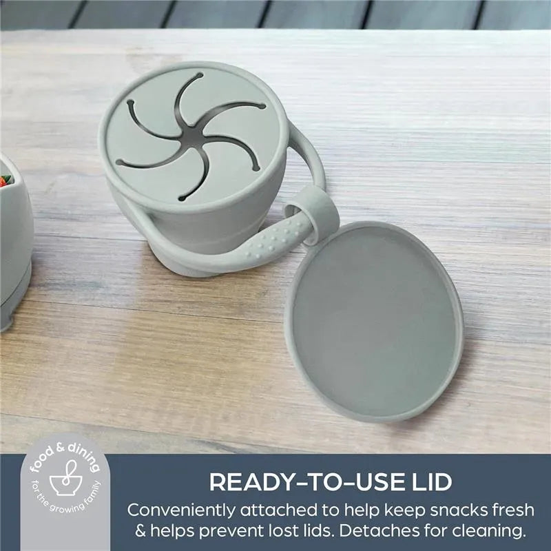 Foldable snack cup in seafoam with a ready-to-use lid, designed to keep snacks fresh and prevent lost lids.