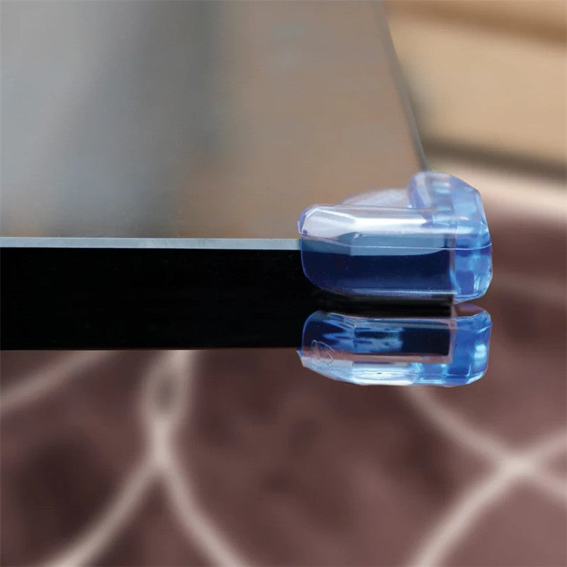 Clear corner cushions protecting glass table edges, designed to enhance safety for children and prevent injuries.