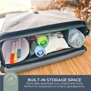 Storage bag showcasing colorful markers, baby essentials, and a bottle, emphasizing built-in storage for on-the-go convenience.