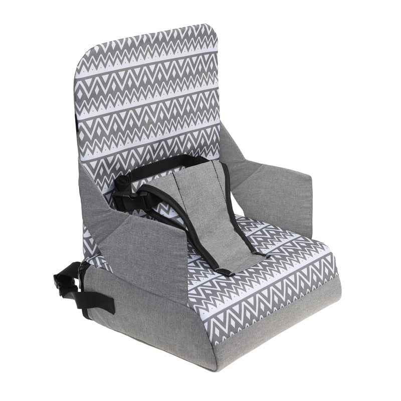 Booster seat featuring a zigzag grey design, with a harness for safety and designed for easy portability.
