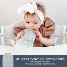 Toddler using a Dreambaby Pouch Pal, designed to prevent mess during feeding, with visible text highlighting its features.