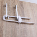 Sliding locks in white with a catch, designed for securing cabinets or doors, mounted on a wooden surface.