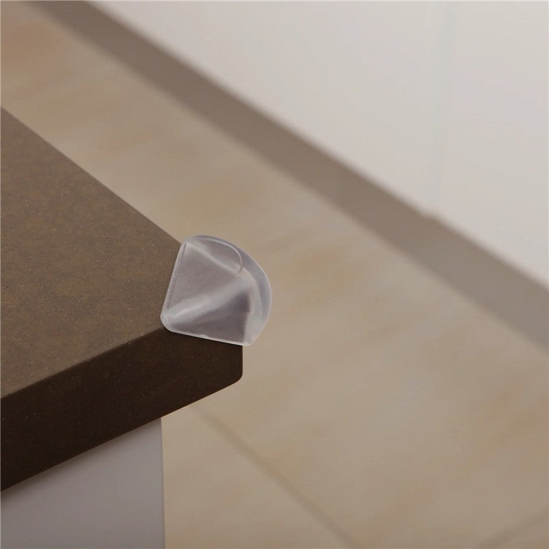 Soft Touch Corner Cushion placed on a brown table edge, designed to protect against sharp corners.