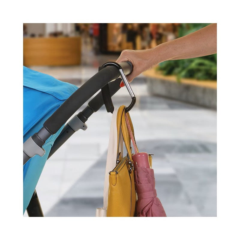 Stroller hook holding several bags, including a pink umbrella and yellow purse, attached to a stroller handle.