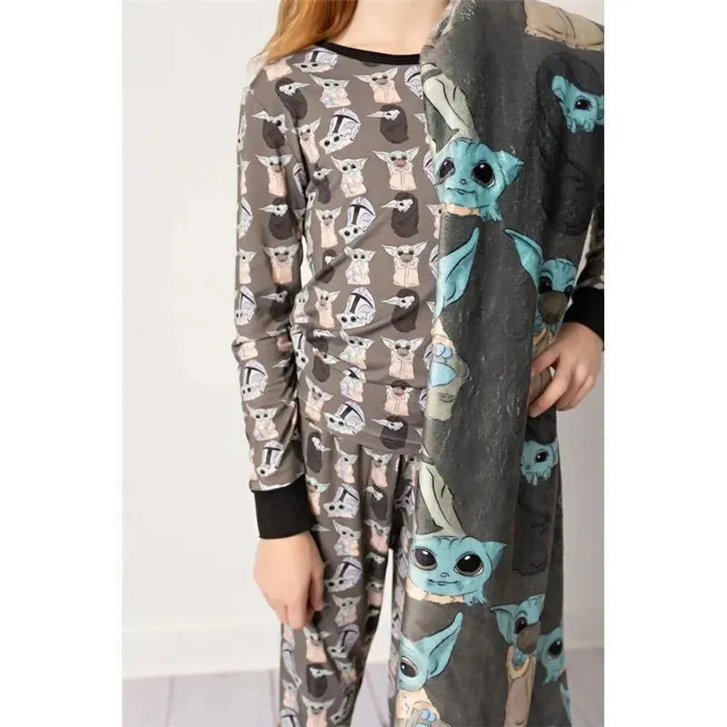 Baby Precious Cargo Bamboo Pajamas featuring playful designs of adorable characters on a gray background, worn by a child.