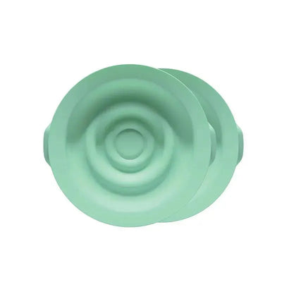 Breast pump seals in a soft green color, designed for enhancing breastfeeding comfort, sold in a 2-pack.