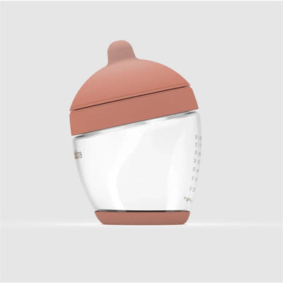 Glass classic bottle with a medium-sized, pink silicone nipple, designed for feeding.