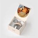 Glass classic baby bottle with medium nipple shape in an Emulait packaging featuring an image of a parent feeding a baby.