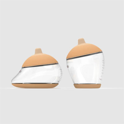 Two Emulait baby bottles with a light nipple color and unique shape, featuring clear bodies and measurement markings.