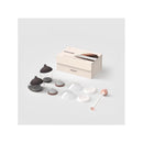 Starter kit for Emulait, featuring two glass containers with dark lids, assorted silicone parts, and a cleaning brush.