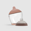 Classic bottle nipple in medium size with a brown lid and clear body, designed for infants.