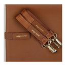 Brunette Enya Mond Luna Diaper Bag detail showing logo patch and zipped straps on a textured brown material.